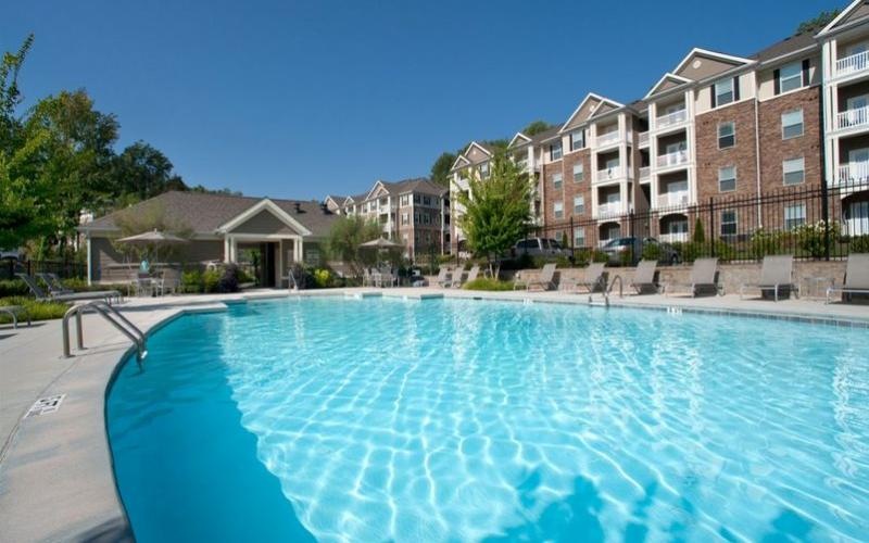 Resort-style swimming pool with lounge seating