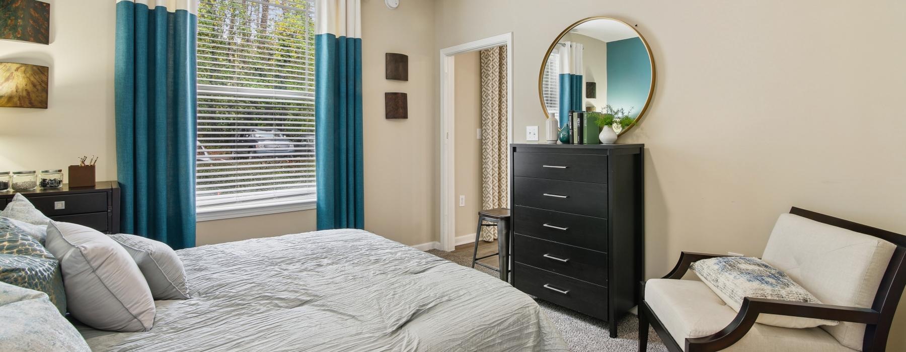 a bedroom with a bed and a chair