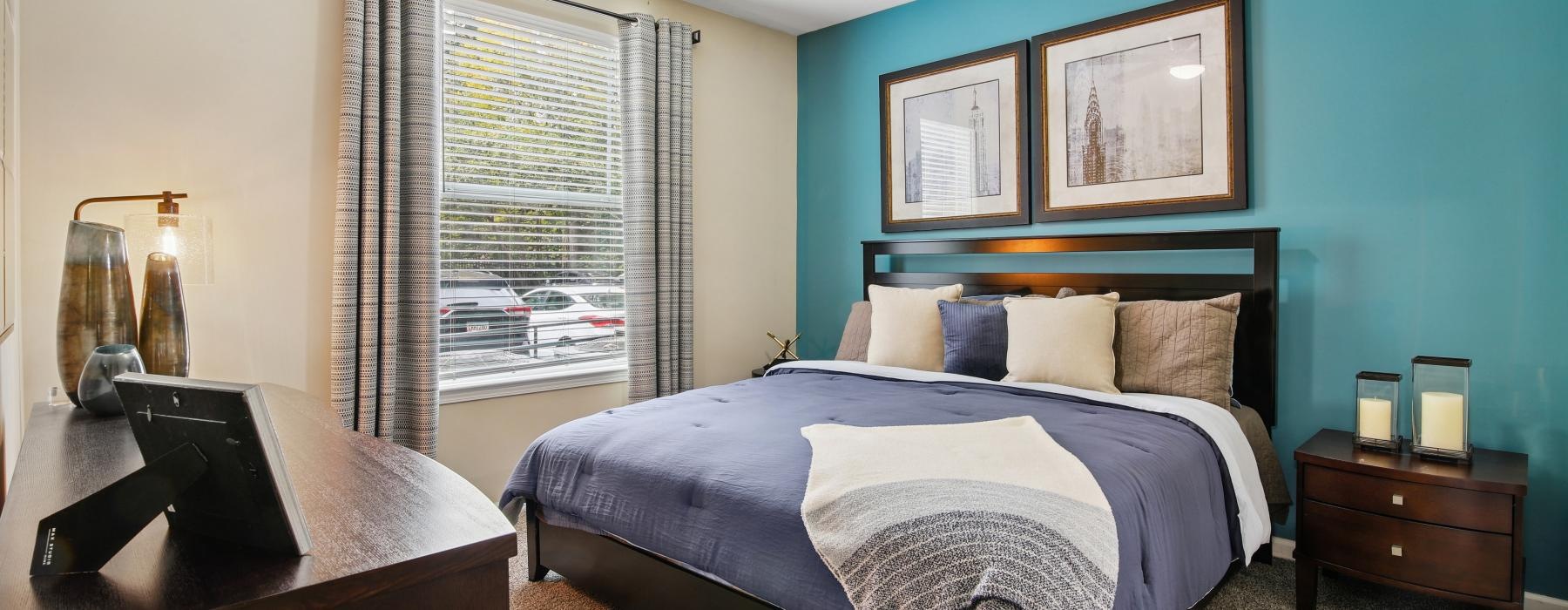 a bedroom with a fan and a bed