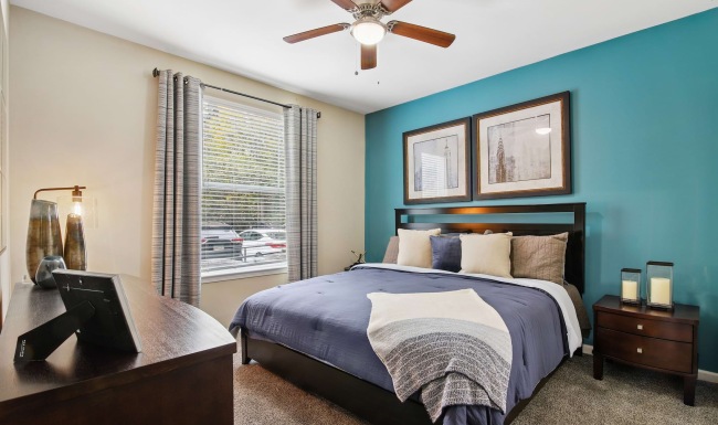 a bedroom with a fan and a bed